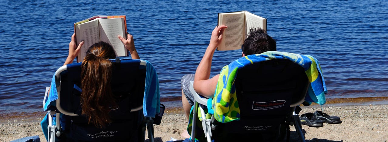 couple reading books on the beach.